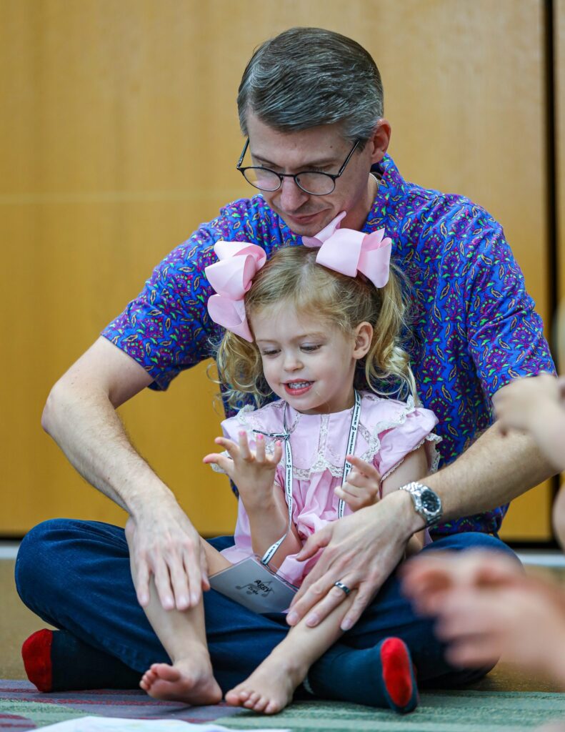 Parent and child in classroom during American Suzuki Institute.