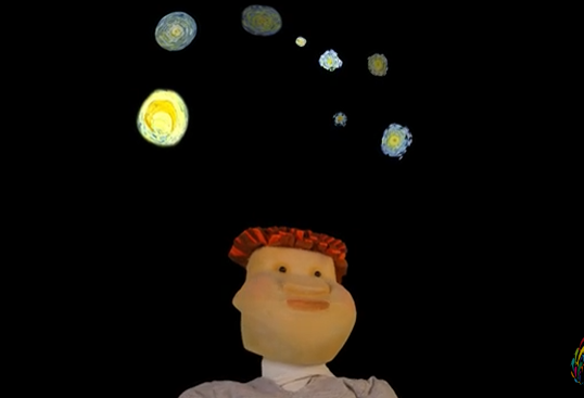puppet looks at model planets in night sky