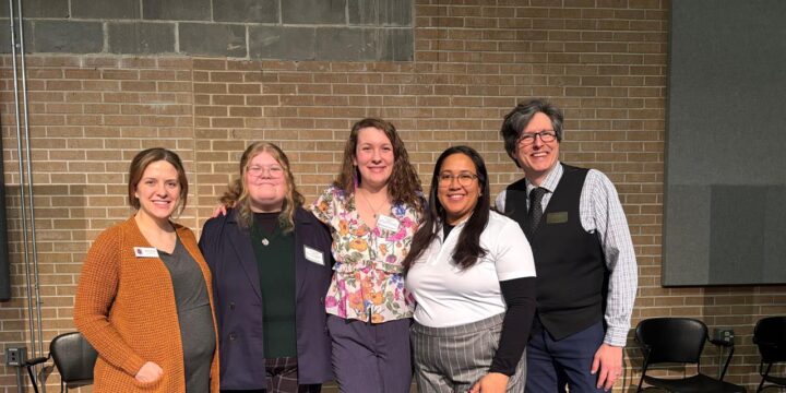 Four students in career panel stand with assistant dean Tobias Barske in the Encore at UWSP.
