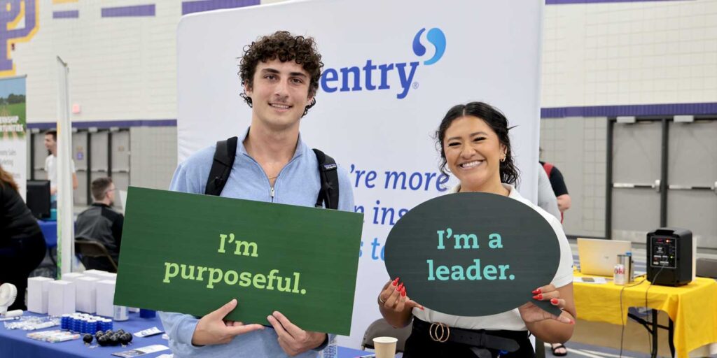 A student visits an employer at a career fair.