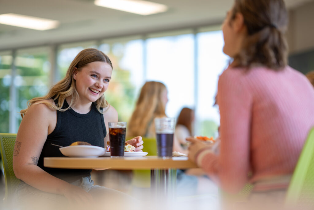UWSP Students eating food at table in Upper DeBot Dining Center