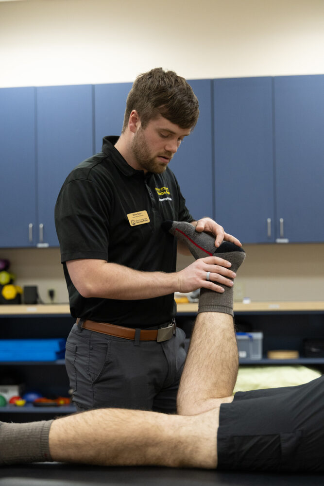 DPT student Drew Sayer works with a patient at the community clinic located in the Stevens Point YMCA.