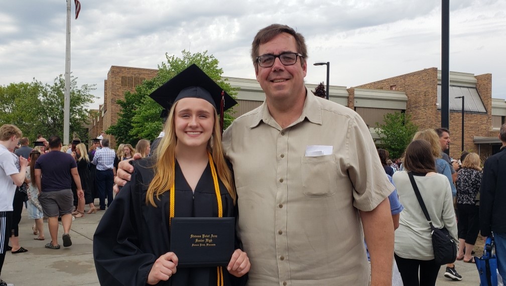 Gracie Gundersen and her father John at her high school graduation