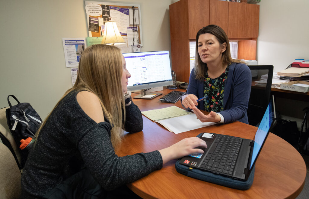 a student meeting with an advisor on campus