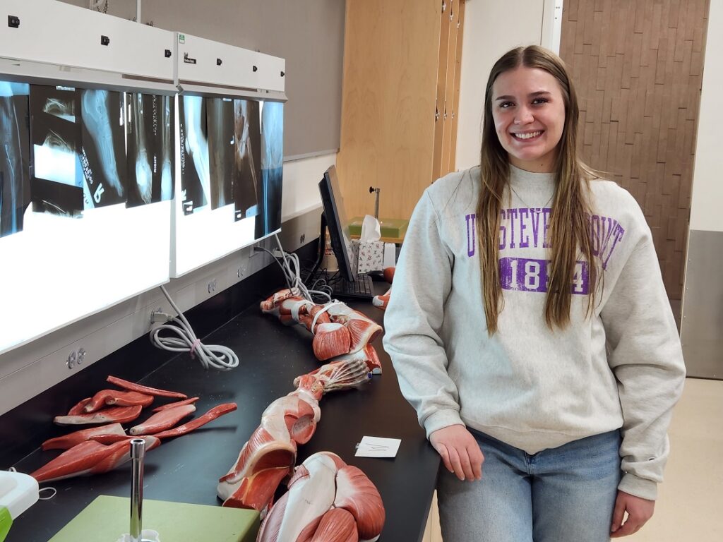 Pre-physician student stands in front of x-ray inside anatomy lab at UWSP.