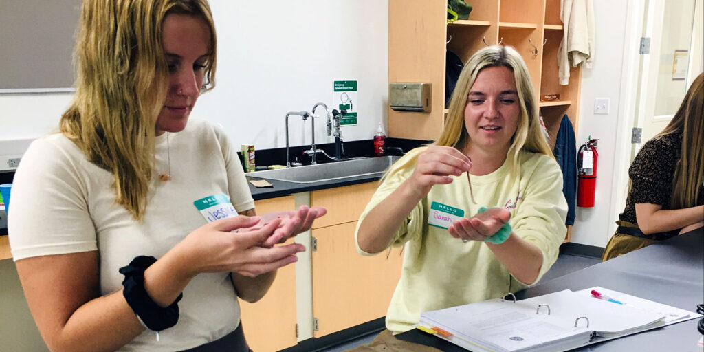 Students in a science lab handling small samples during a hands-on classroom activity.