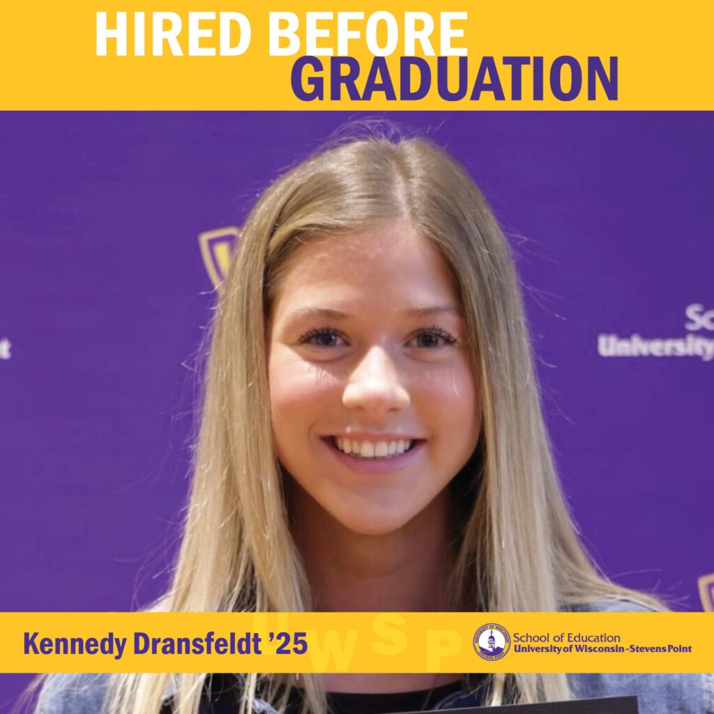 Student standing in front of a purple UWSP School of Education backdrop with “Hired Before Graduation” displayed at the top.
