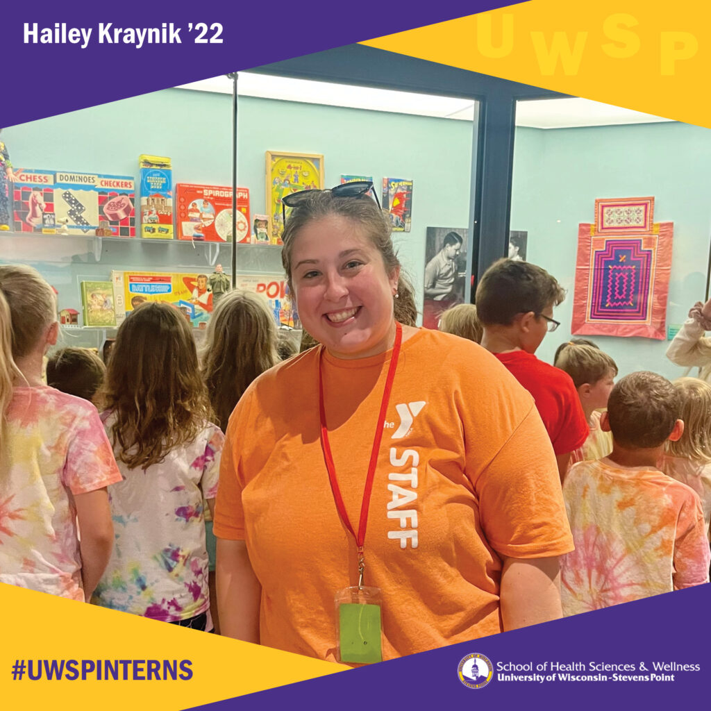 Student interning at the YMCA with children behind her.