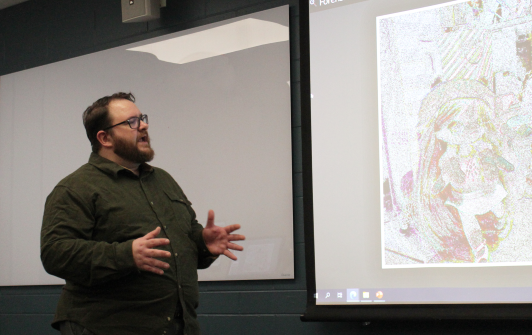 Professor Chad Johnson shows an image on screen in lecture