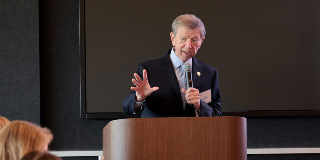 Sentry CEO Pete McPartland addressing attendees from a podium during a formal presentation