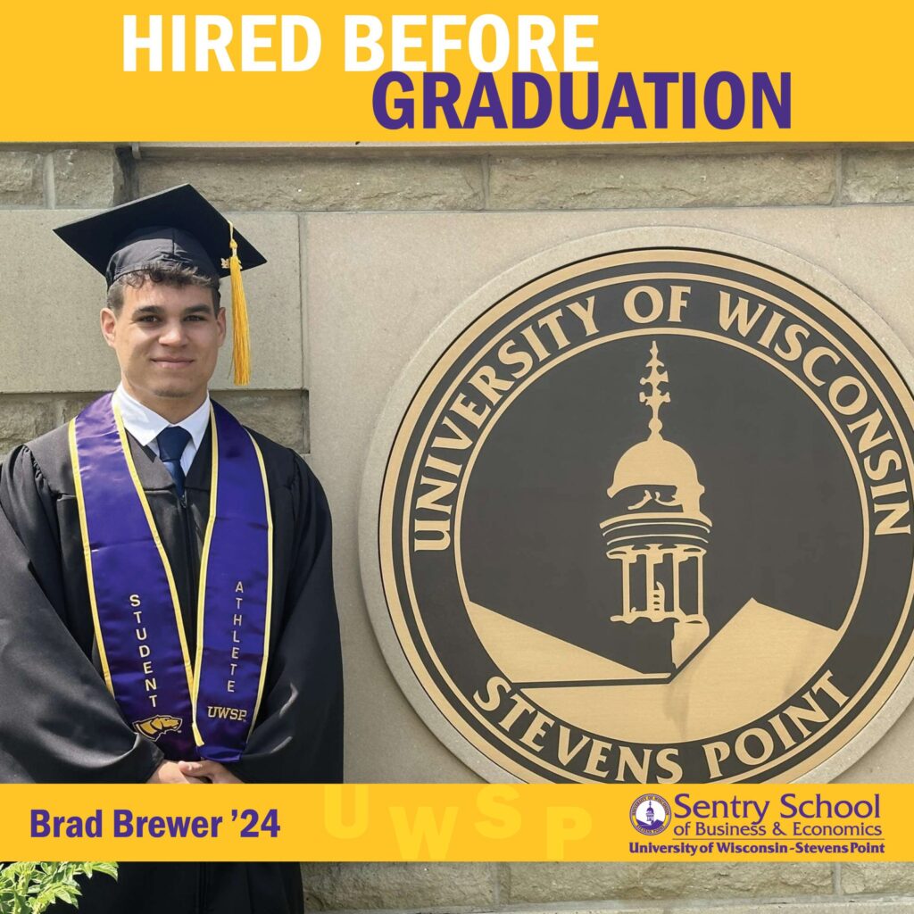 Graduate in cap and gown standing by the UW–Stevens Point seal with the text “Hired Before Graduation” and “Brad Brewer ’24” for the Sentry School of Business & Economics