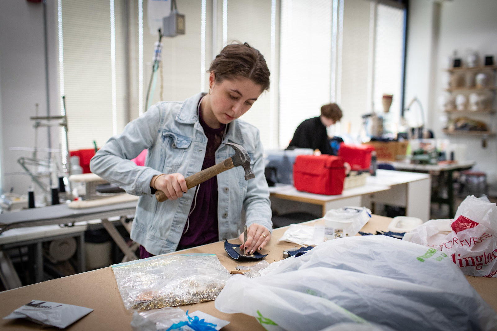 Student creating a costume or prop for a stage production.