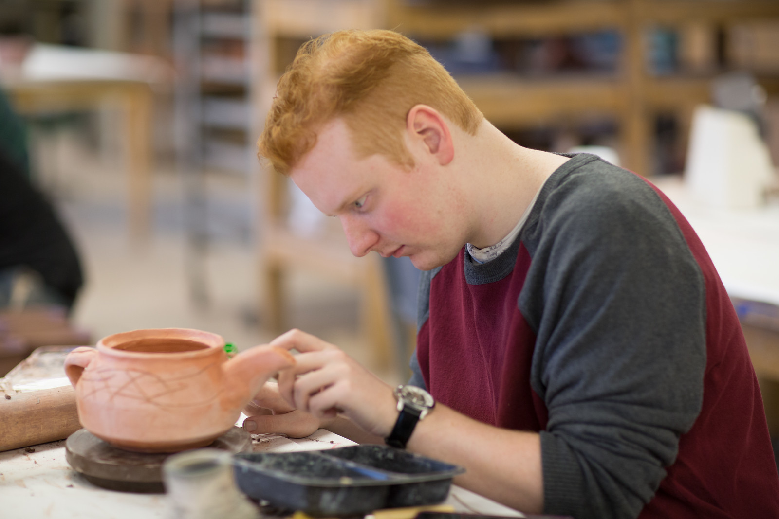 Student creating a ceramics piece in the studio.