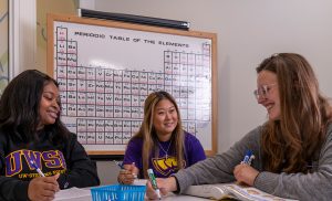 Three female students in the STEM tutoring center.