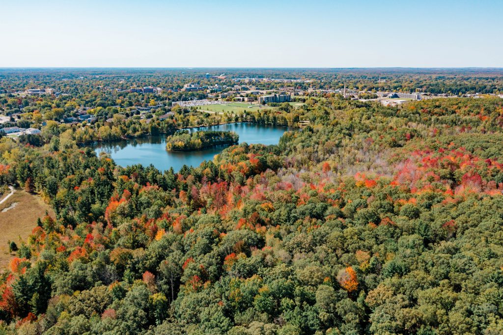 Overview of campus leaves changing colors in fall with Lake Joanis.