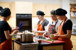 Dietetics students working in a food lab with a professor.