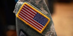 An American flag badge on an army uniform.