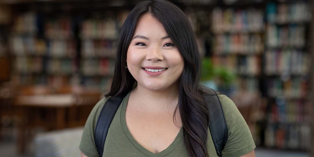 Student Sandy Vang from Wausau campus in the library.