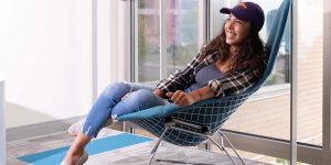 A student sitting in a chair inside the Dreyfus University Center.