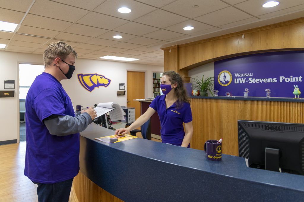 Two people standing at the Solution Center on the Wausau campus.