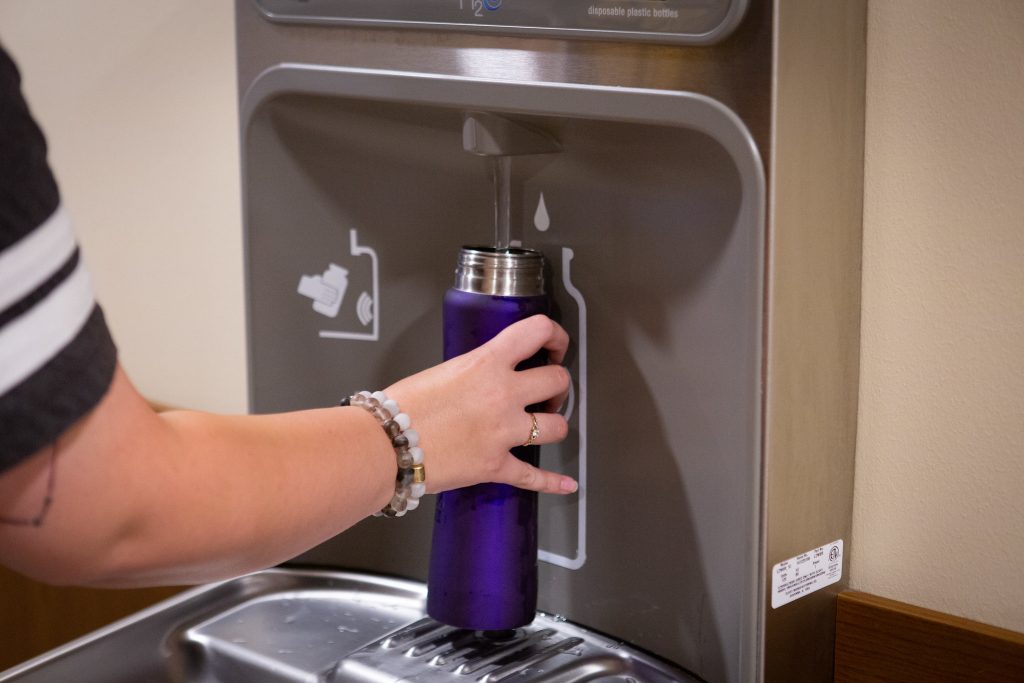 A student filling up their reusable water bootle at our water station.