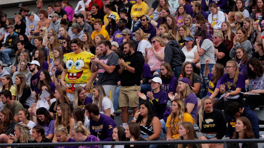 A crowd of students cheering on the Pointer football team.