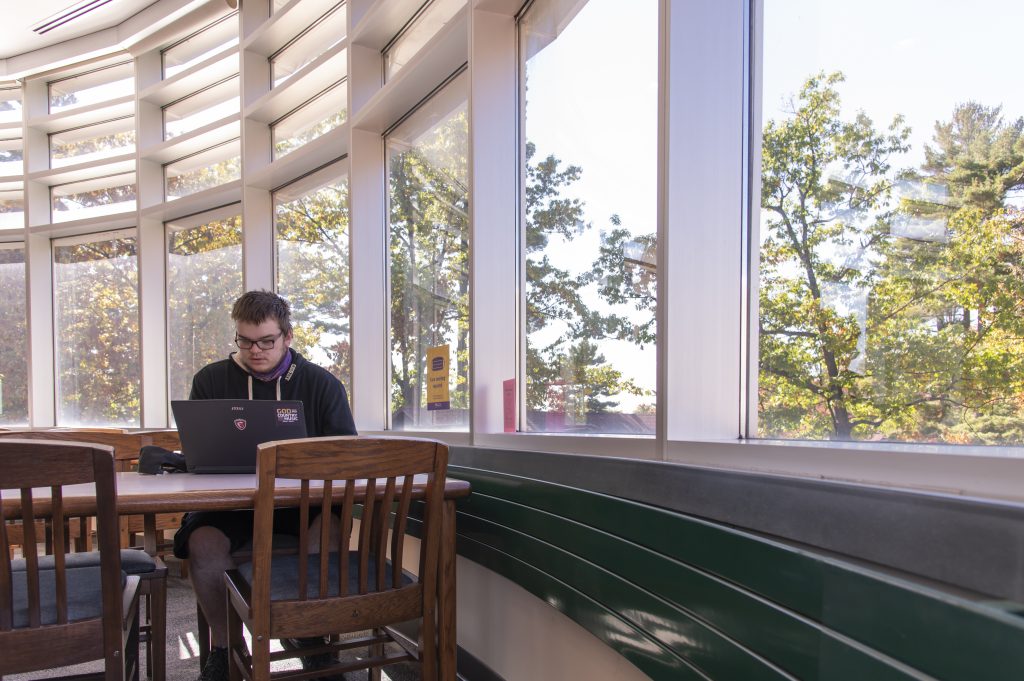 Wausau student studying at a table in the library.