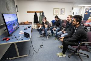 Students playing video games while taking a study break.