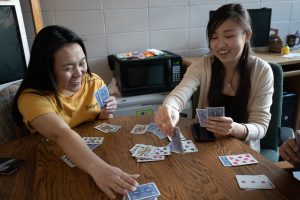 Group of students playing cards on a study break.