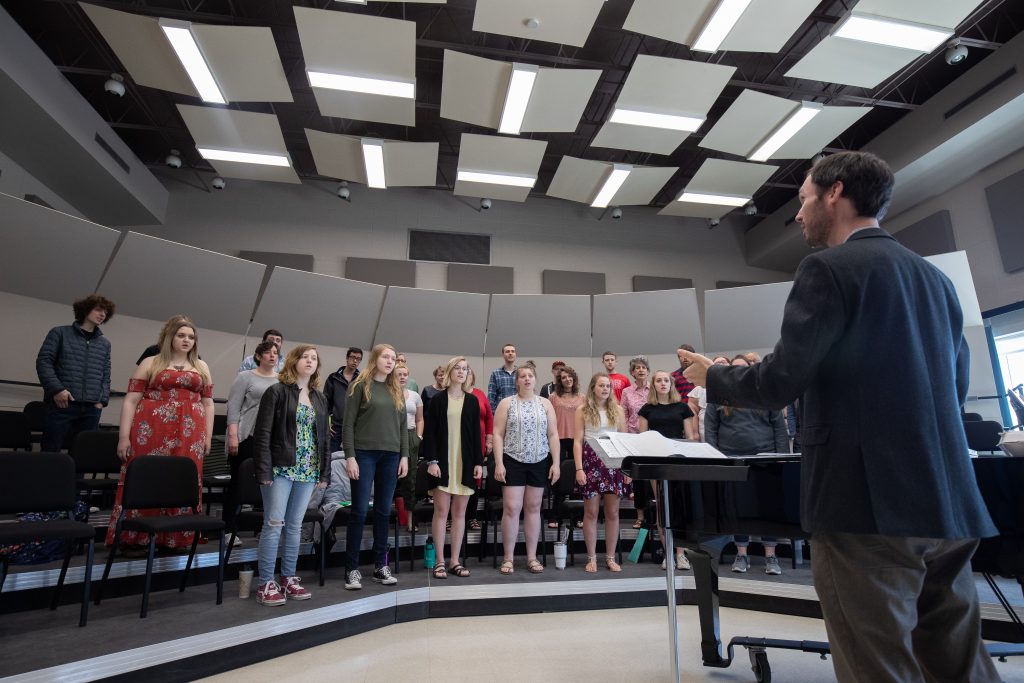 Professor instructing a choir during class.