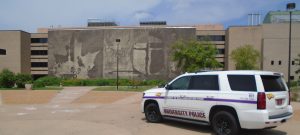 The University Police car parked in front of our campus mural.
