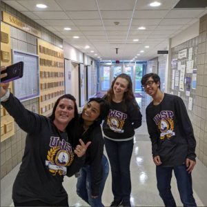 Student ambassadors smiling and taking a selfie together.
