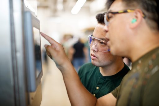 Student and professor working on the paper machine.