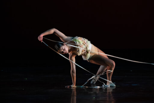 Dance student posing on stage at a dance event