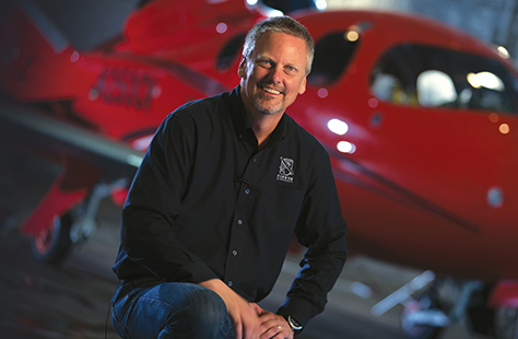 Alumni Dale Klapmeier next to his airplane.