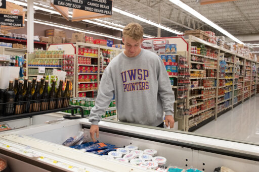 Student shopping for items at Triggs