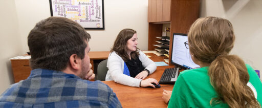 Two students and an adviser in the Academic and Career Advising Office.