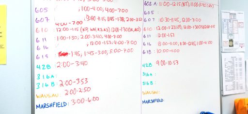 White board with dates and times written on it