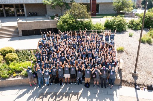 A group of LEAD students throwing their hands up in the air.