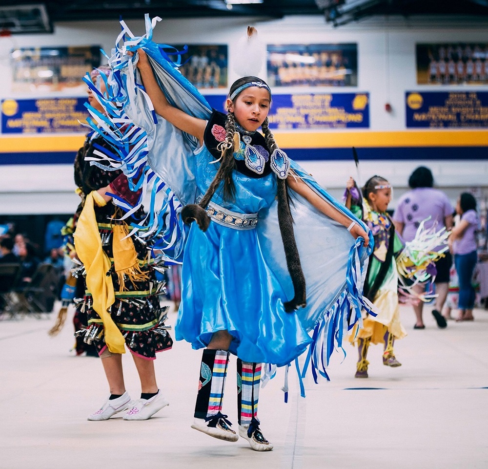 A Native American child performs at the AIRO Pow Wow in MCCH Athletic Space