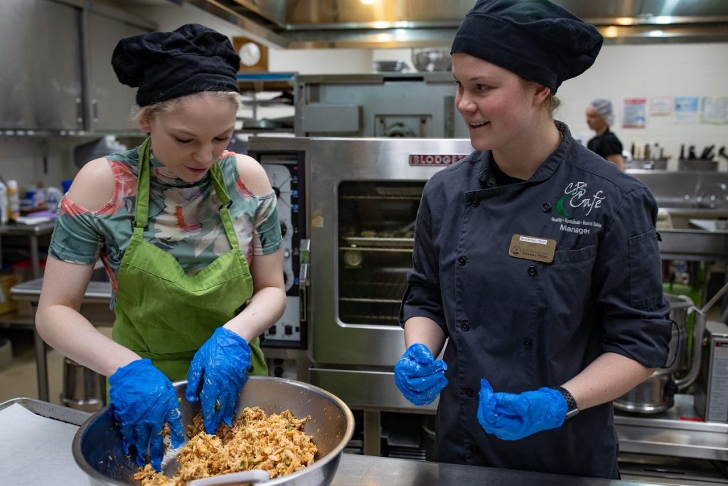 Students Jade Romatowski and Brookelyn Heiss work in the CPS Cafe