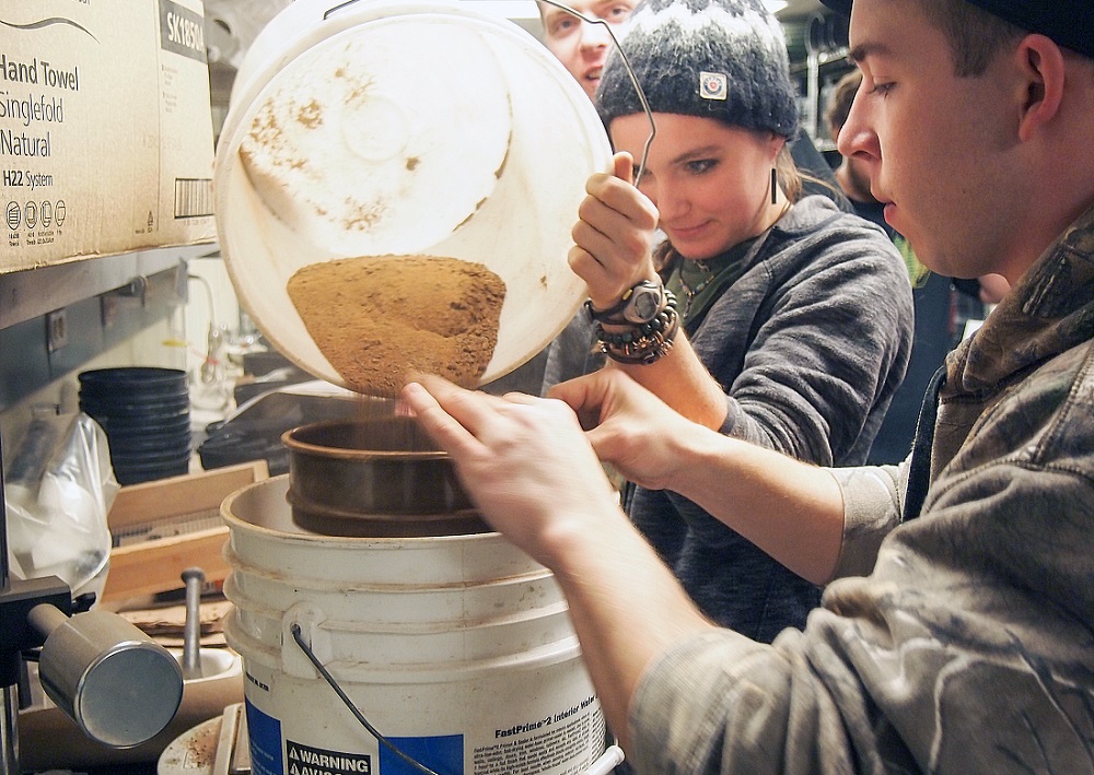 Students sieving soil