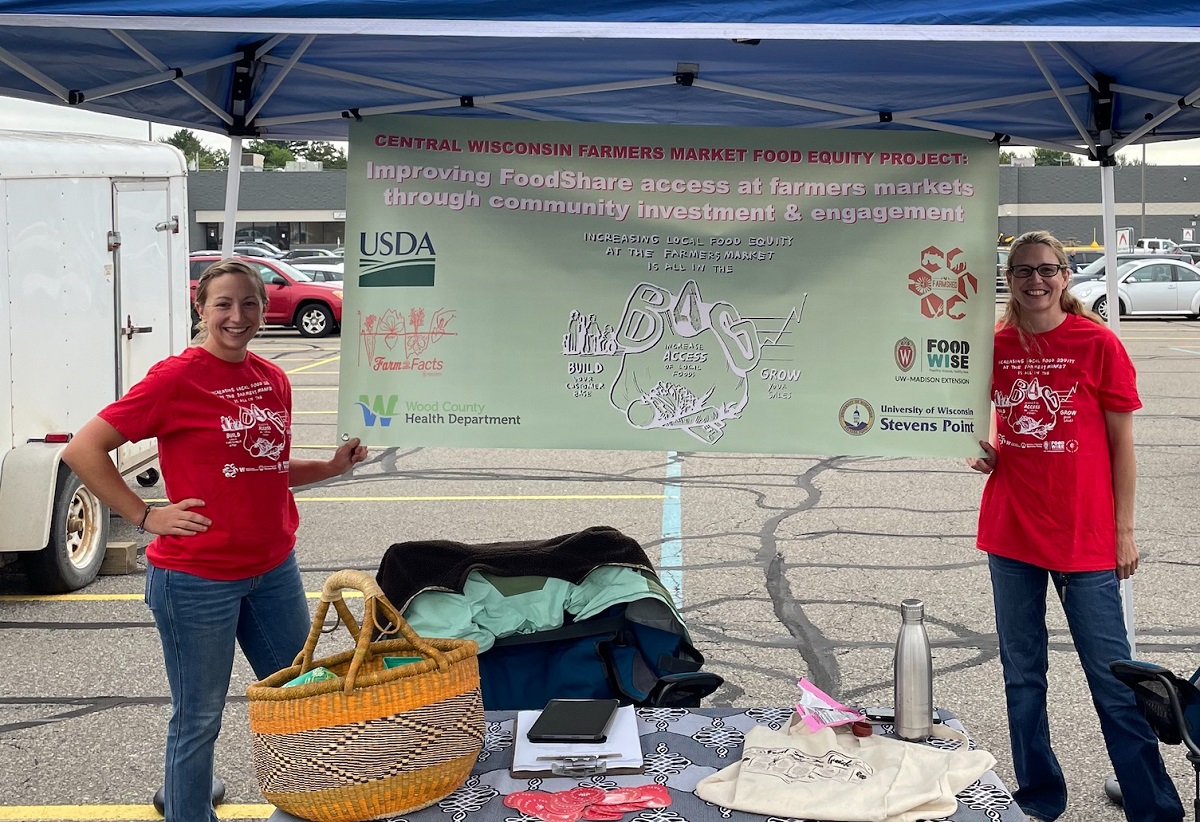 Alumna Taylor Christiansen (left) and Alissa Lick, graduate assistant in the Sustainable and Resilient Food Systems program at UW-Stevens Point, are at the Marshfield farm market, one of six where customers and vendors are being surveyed.