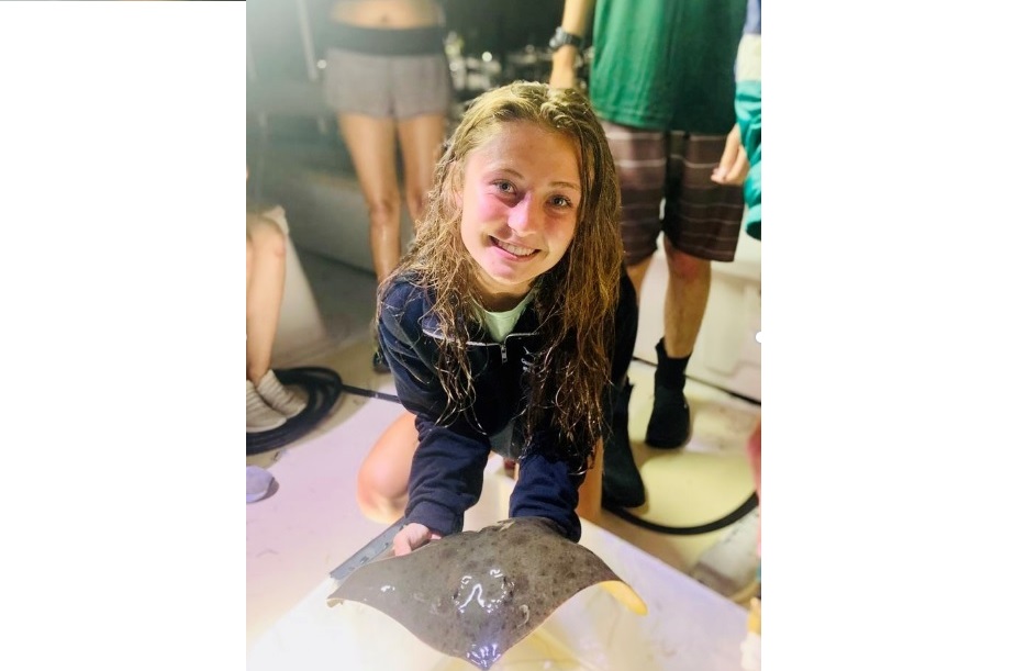 Lexi Kandziora holds a butterfly ray