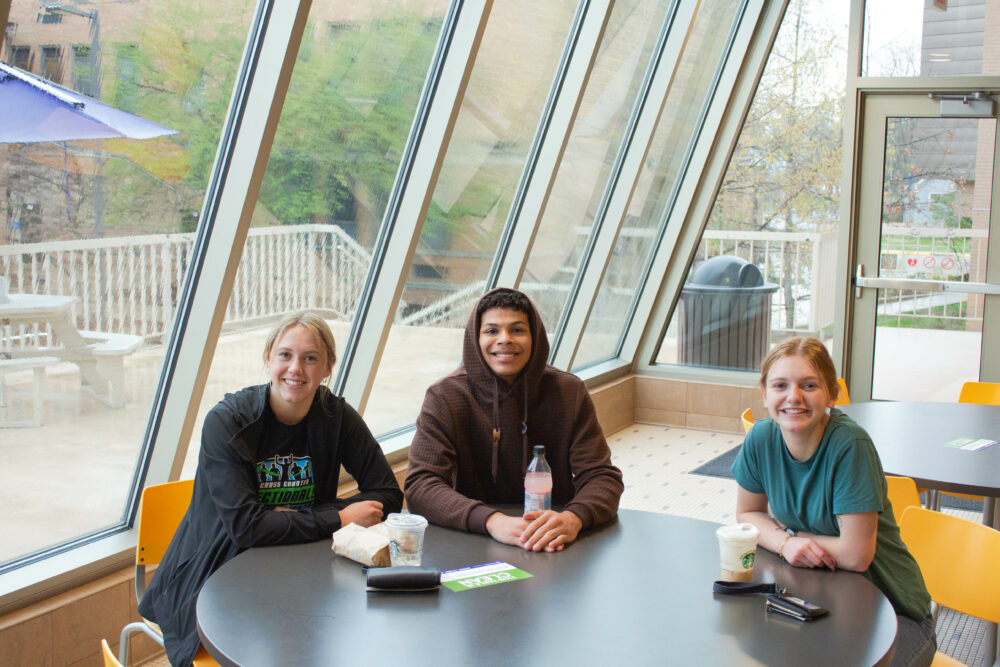 Three students talking at the duc food court