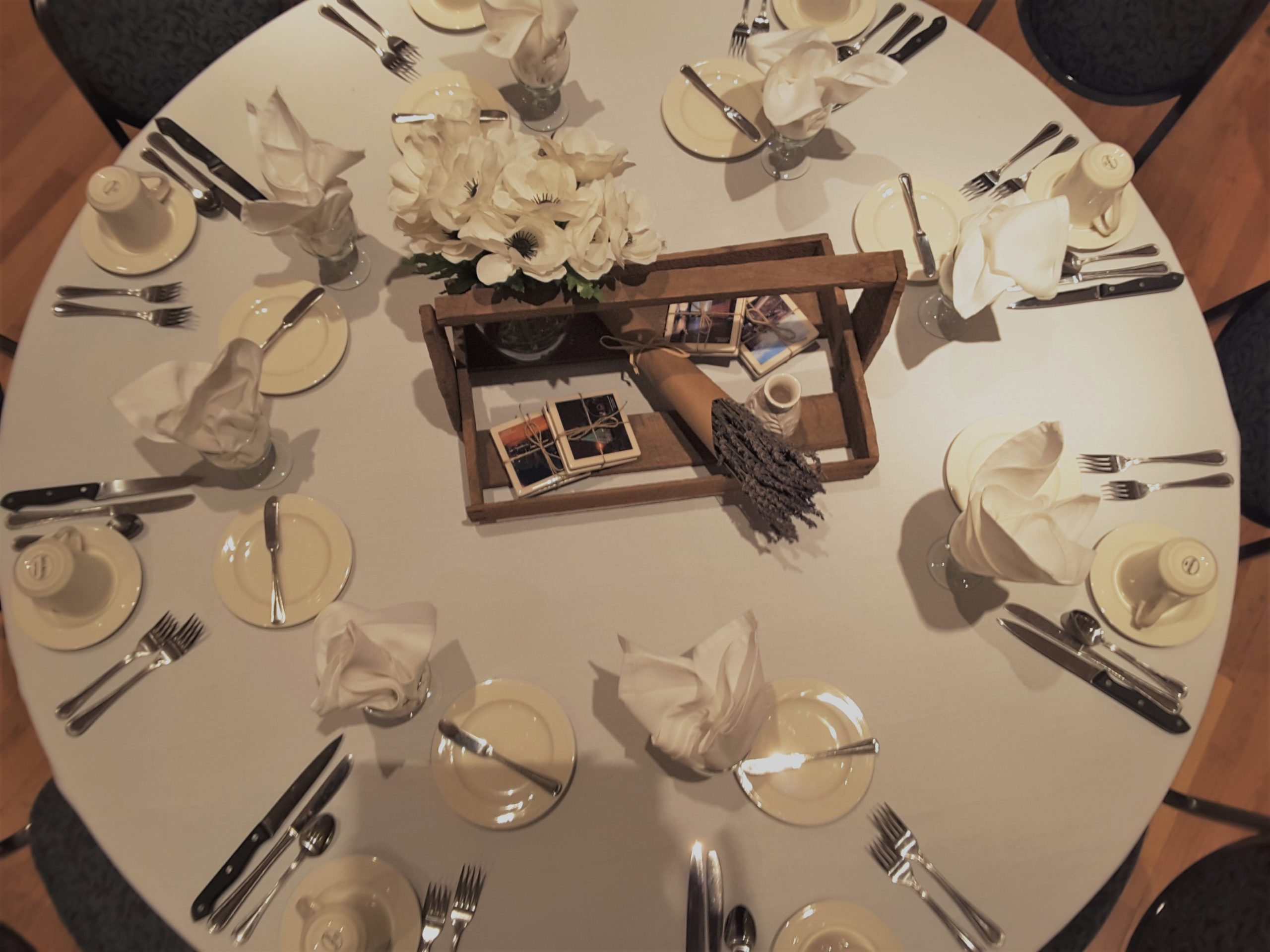 Table set up with white flowers and rosemary