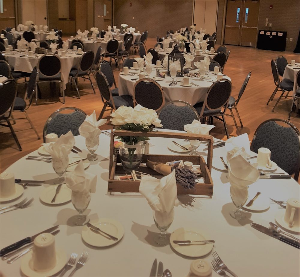 Table set up with white flowers and rosemary