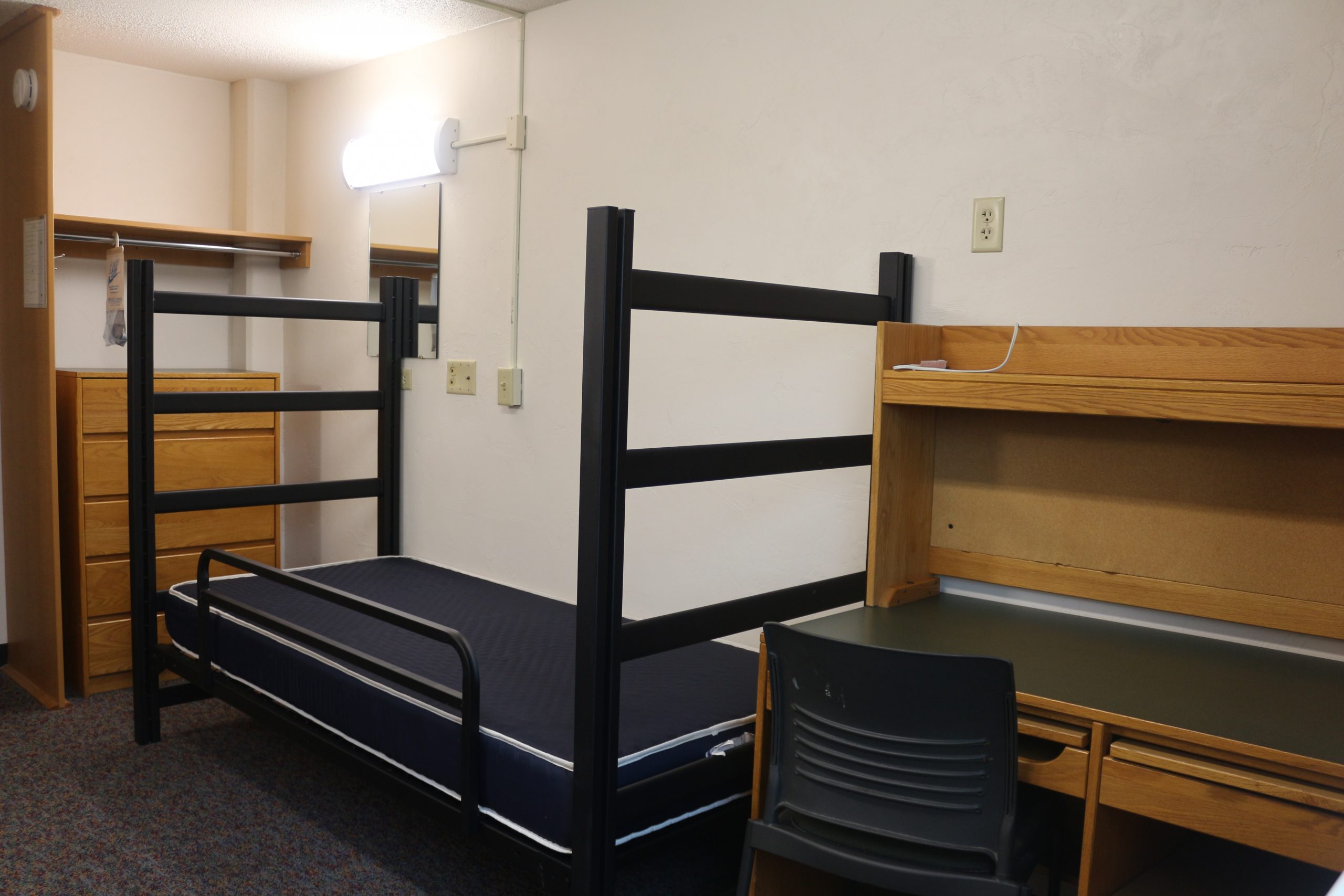 Room showing bed and desk
