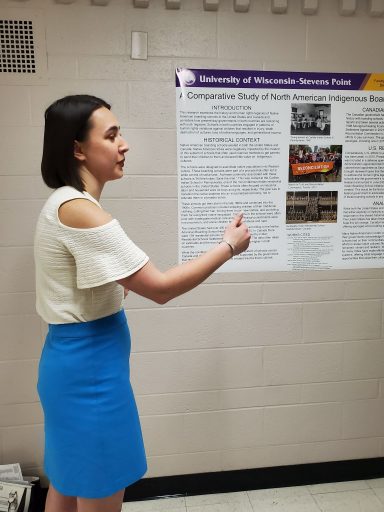 student explains research poster