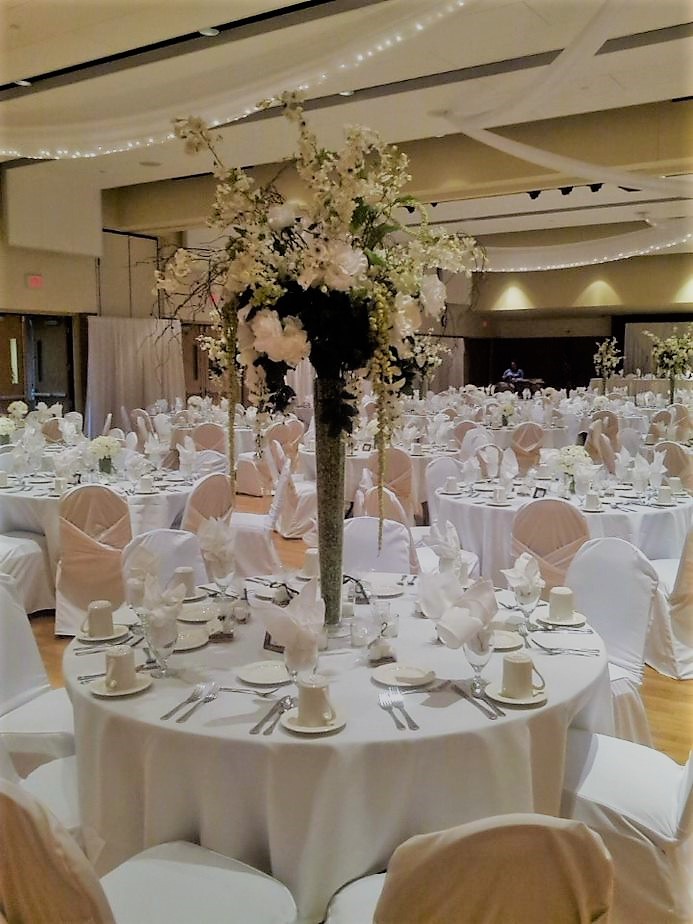 Wedding tablescape with white linens and tall florals